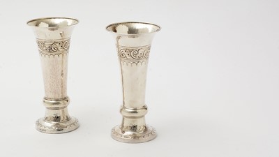 Lot 37 - A pair of George V arts and crafts silver vases with flaring rims