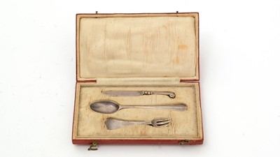 Lot 150 - An early 18th Century miniature three-prong wavy-end fork; and a Hanoverian spoon