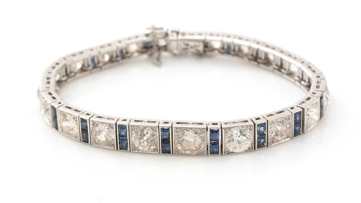 Lot 557 - A fine graduated diamond and sapphire bracelet
