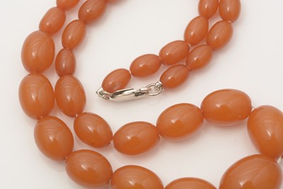 Lot 702 - An amber bead necklace