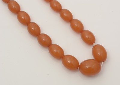 Lot 702 - An amber bead necklace