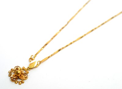 Lot 165 - An 18ct yellow gold floral pendant on fancy link chain