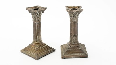 Lot 1023 - A pair of silver Corinthian column candlesticks, by Charles Boyton & Sons