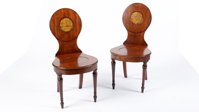 Lot 1316 - A pair of early 19th Century mahogany hall chairs