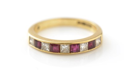 Lot 763 - A ruby and diamond half hoop eternity ring