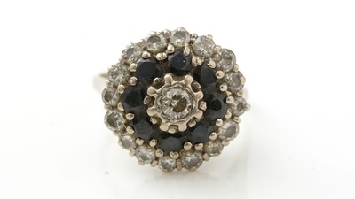 Lot 987 - A sapphire and diamond cluster ring