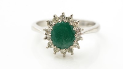 Lot 940 - An emerald and diamond cluster ring