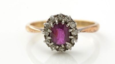 Lot 910 - A ruby and diamond cluster ring