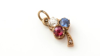 Lot 911 - A sapphire, ruby and diamond pendant