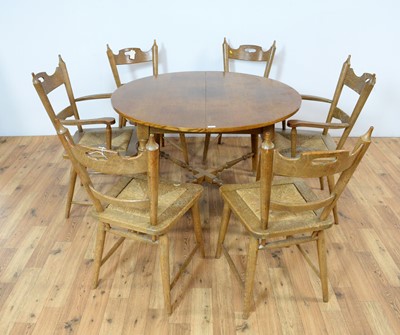 Lot 11 - An oak extending dining table and chairs