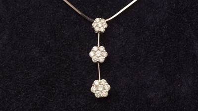 Lot 565 - A diamond triple cluster pendant