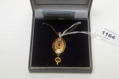 Lot 1164 - A 14ct yellow gold garnet and enamel locket pendant, by Royal Doulton