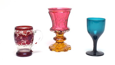 Lot 919 - A Bohemian cranberry and amber glass goblet, ruby flash cup, green wine glass