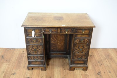 Lot 84 - An  oak Jacobean Revival kneehole desk of small proportions