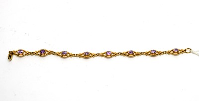 Lot 1180 - An amethyst and 9ct yellow gold bracelet