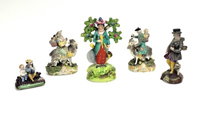 Lot 830 - Four Staffordshire figures, another.
