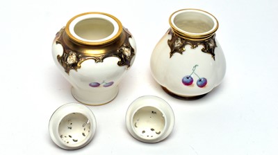 Lot 870 - Two small Royal Worcester pot pourri vases and covers by Roberts