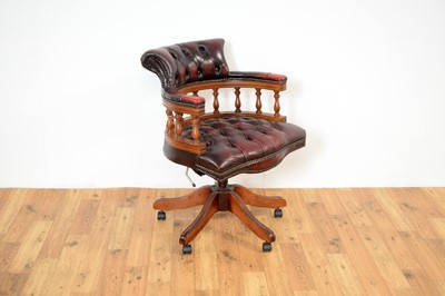 Lot 9 - A reproduction mahogany and oxblood leatherette captain's chair