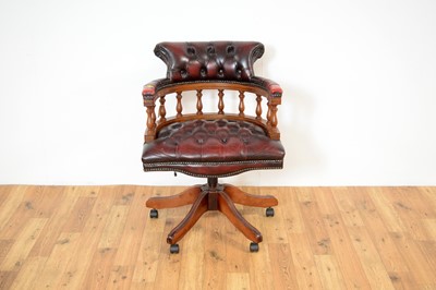 Lot 9 - A reproduction mahogany and oxblood leatherette captain's chair