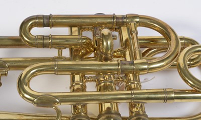 Lot 728 - A brass cornet by Joseph Wallace London.