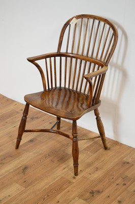 Lot 23 - A 19th Century yew and elm comb back Windsor chair