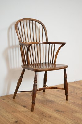 Lot 23 - A 19th Century yew and elm comb back Windsor chair