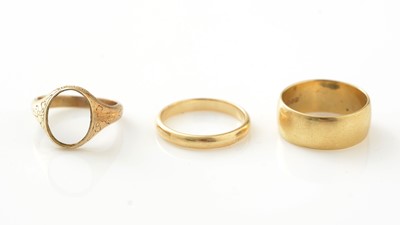 Lot 780 - Two 18ct yellow gold wedding bands, and another ring