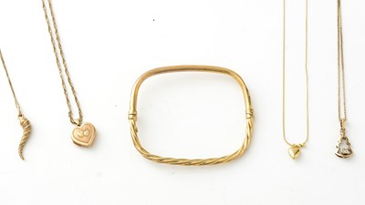 Lot 815 - Gold pendants on chains, and a bangle