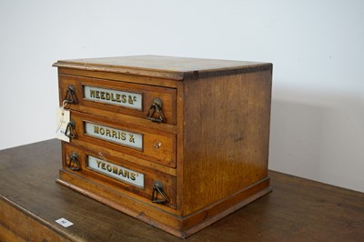 Lot 53 - An early 20th Century table top three drawer oak needle/haberdashery cabinet by Morris & Yeomans.