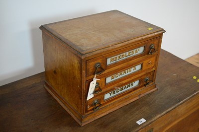 Lot 53 - An early 20th Century table top three drawer oak needle/haberdashery cabinet by Morris & Yeomans.