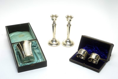 Lot 847 - A French silver beaker, candlesticks and napkin rings