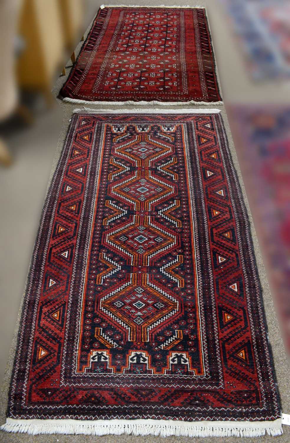 Lot 87 - A 20th Century Persian Baluch rug with another