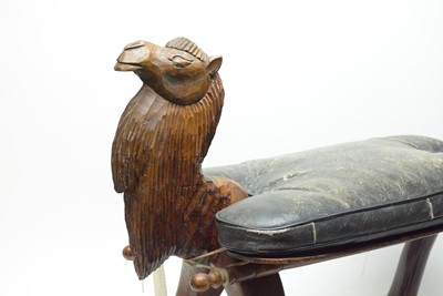 Lot 363 - An Eastern carved wood camel stool