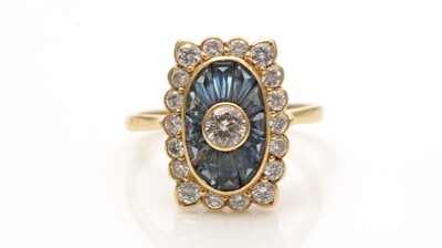 Lot 707 - A sapphire and diamond cluster ring