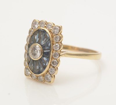 Lot 707 - A sapphire and diamond cluster ring