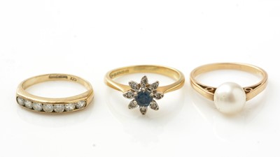 Lot 982 - A sapphire and diamond cluster ring, and two others