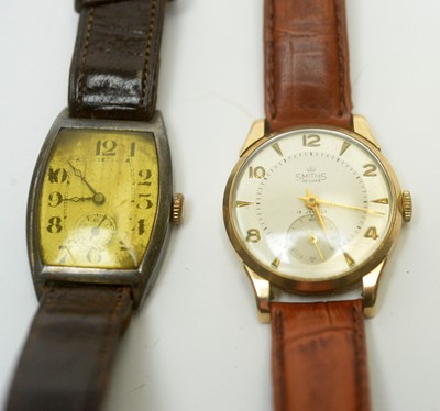 Lot 978 - A Smiths DeLuxe 9ct gold watch, and a 1920s silver tonneau cased wristwatch.