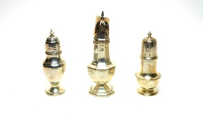 Lot 1022 - Three silver sugar casters