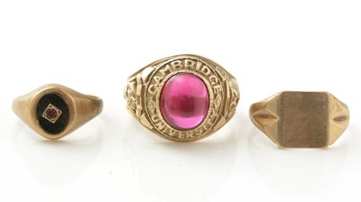 Lot 1030 - A synthetic ruby and 9ct yellow gold Cambridge University ring, and two others