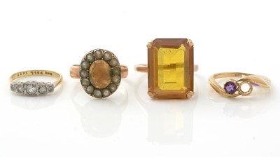 Lot 1070 - A citrine ring, and three others