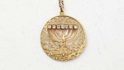 Lot 1077 - A diamond and turquoise set gold Menorah pattern pendant