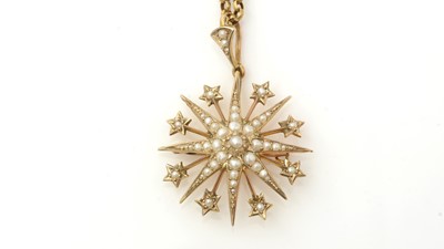 Lot 1119 - An Edwardian seed pearl star pendant/brooch on chain