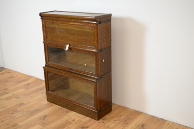 Lot 67 - Attributed to Globe Wernicke - an early 20th Century oak triple sectional bookcase