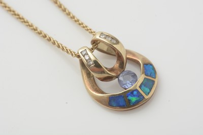 Lot 187 - An opal, diamond and blue stone pendant