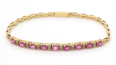 Lot 722 - A ruby, white sapphire and yellow gold bracelet
