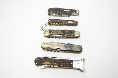 Lot 233 - Five 20th Century multi-purpose folding pocket knives
