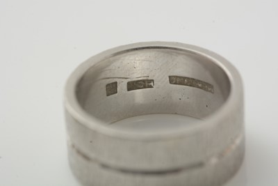 Lot 176 - A platinum wedding band and two other rings