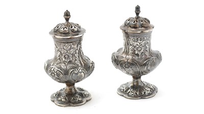 Lot 182 - A matched pair of two very similar William IV silver pepper casters
