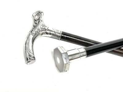 Lot 1141 - A George V silver powder compact evening cane, and an Art Nouveau walking stick.