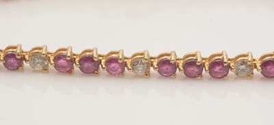 Lot 688 - A diamond and ruby line bracelet